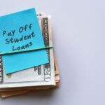 A bundle of cash with a note that says, "Pay off student loans."